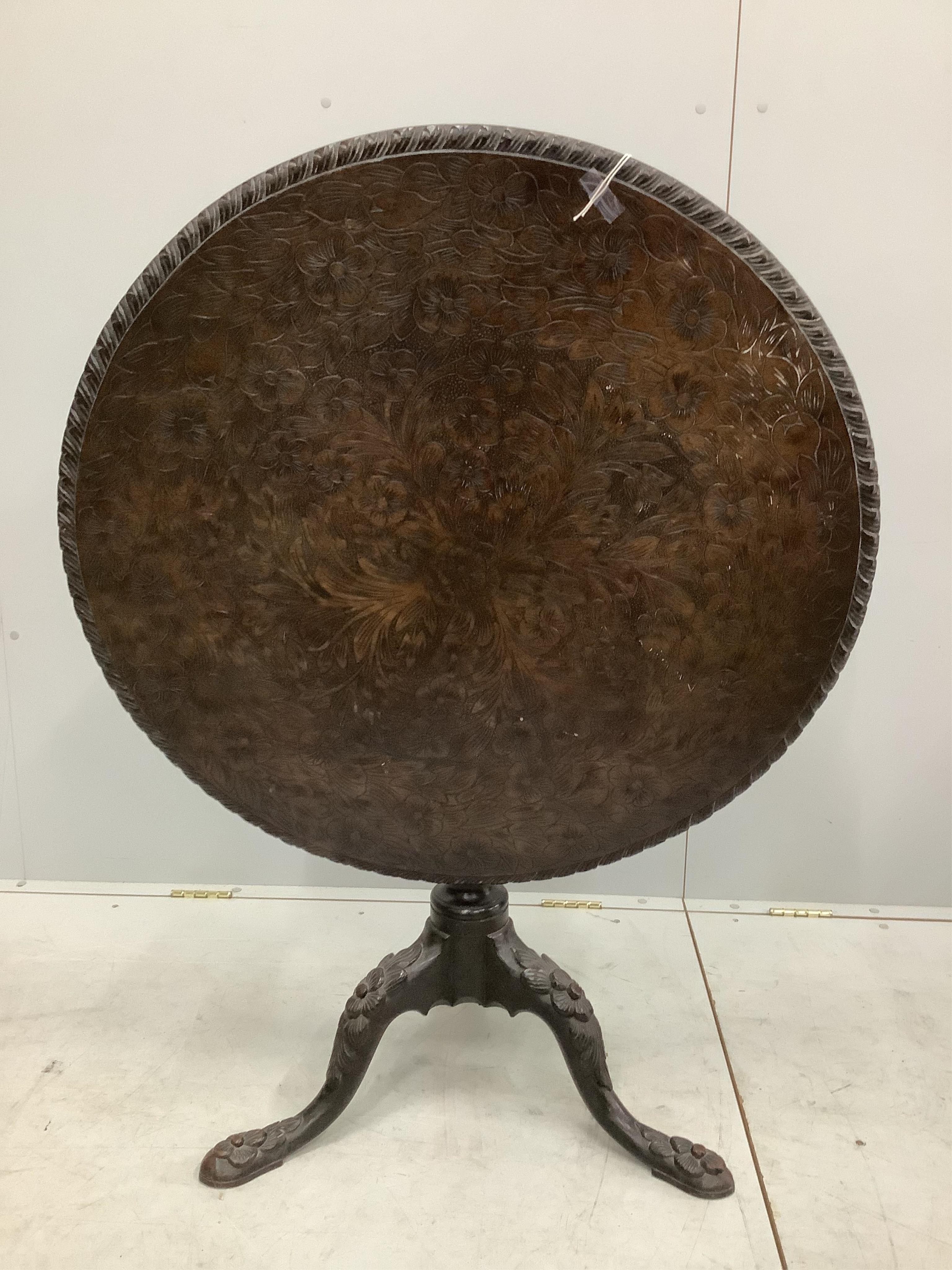 A George III circular mahogany tilt top tea table, later carved, diameter 87cm, height 72cm